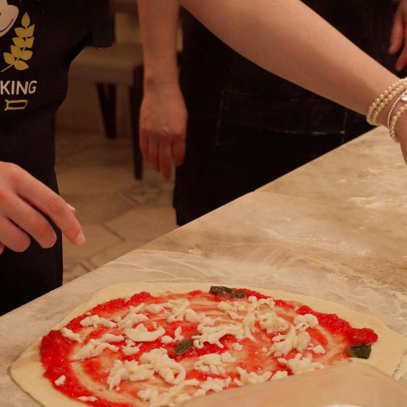 Pizza Topping Tourist topping a pizza during the Pizza Masterclass in Rome