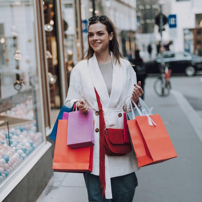 young woman in Via del Corso Young woman walking along Via del Corso in Rome after shopping with boutique bags