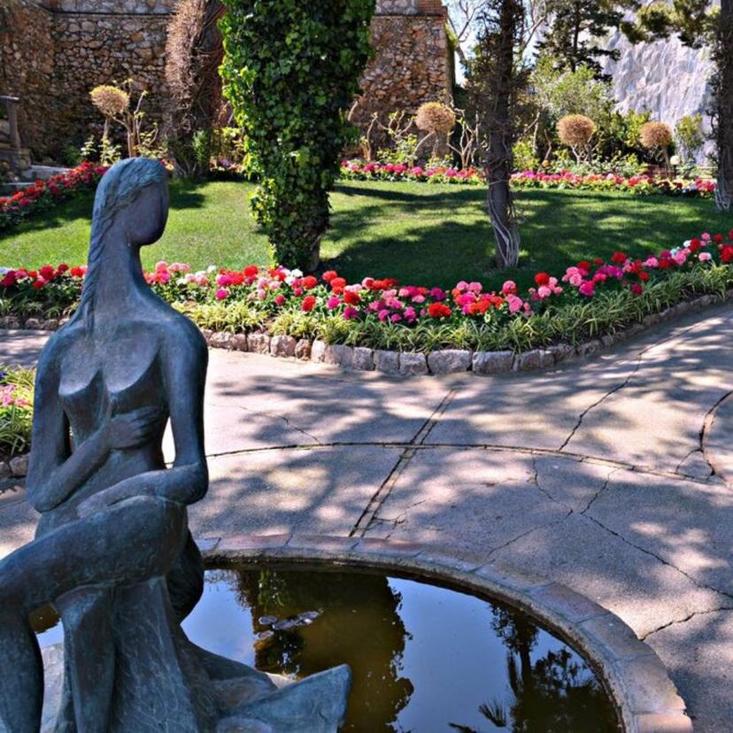 Park in capri Statue in park flowers fountain