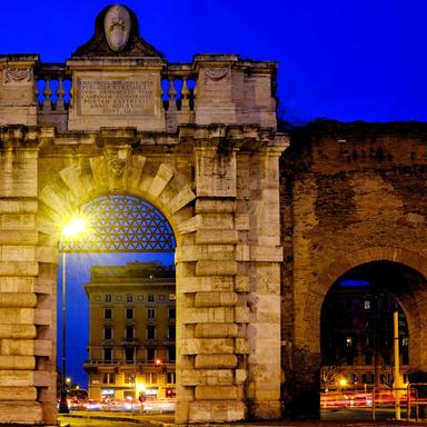 aurelian-walls-porta-san-giovanni Monumental gate of the Aurelian Walls in Rome illuminated at night in Porta San Giovanni