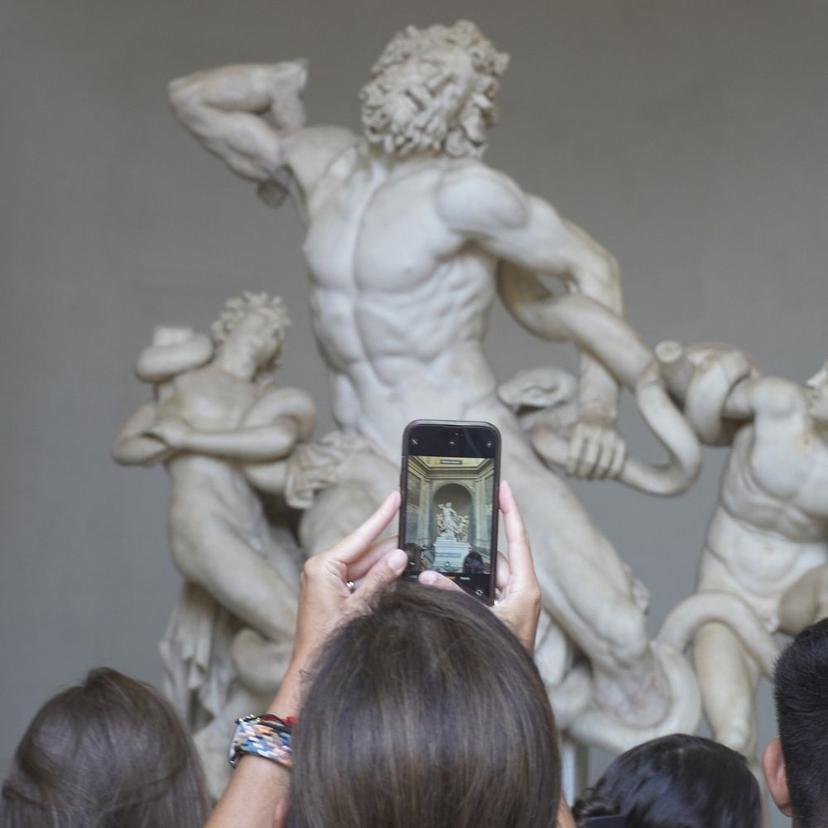 Photographing the Laocoön statue in the Vatican Museums Visitor taking a photo of the Laocoön statue during an early morning Vatican Museums small group tour